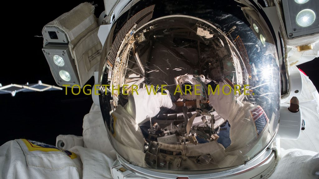 Picture of astronaut with Together We Are More overlaid in yellow text