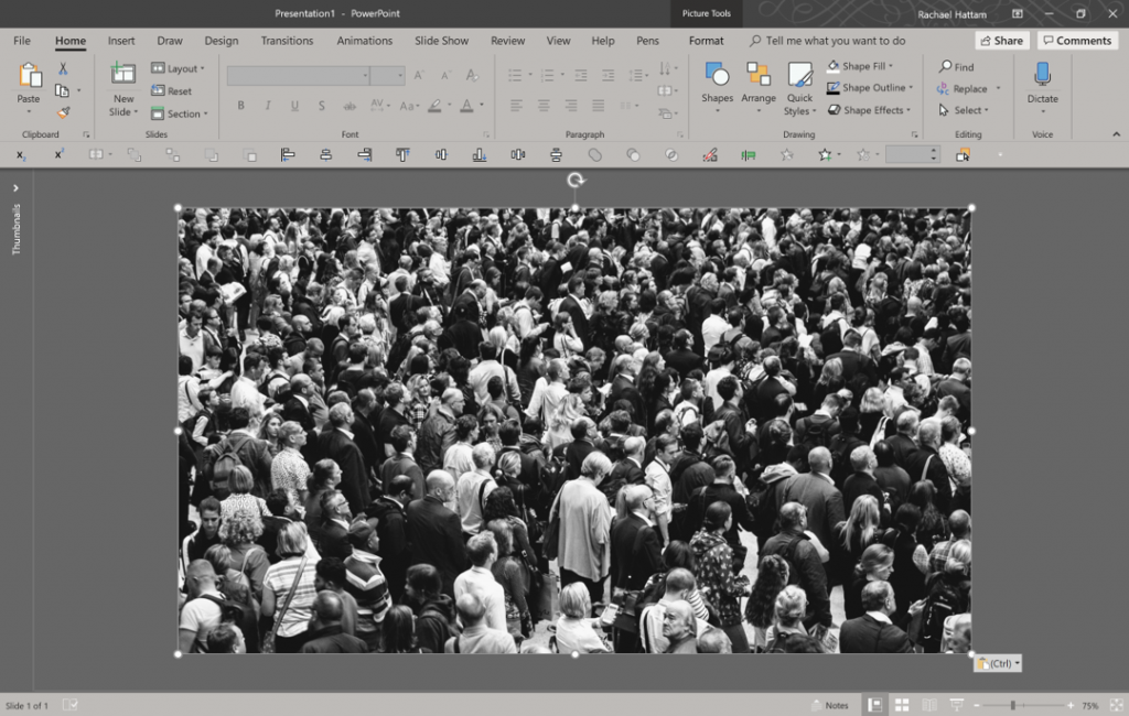 Screenshot of PowerPoint, with full bleed image of a busy crowd