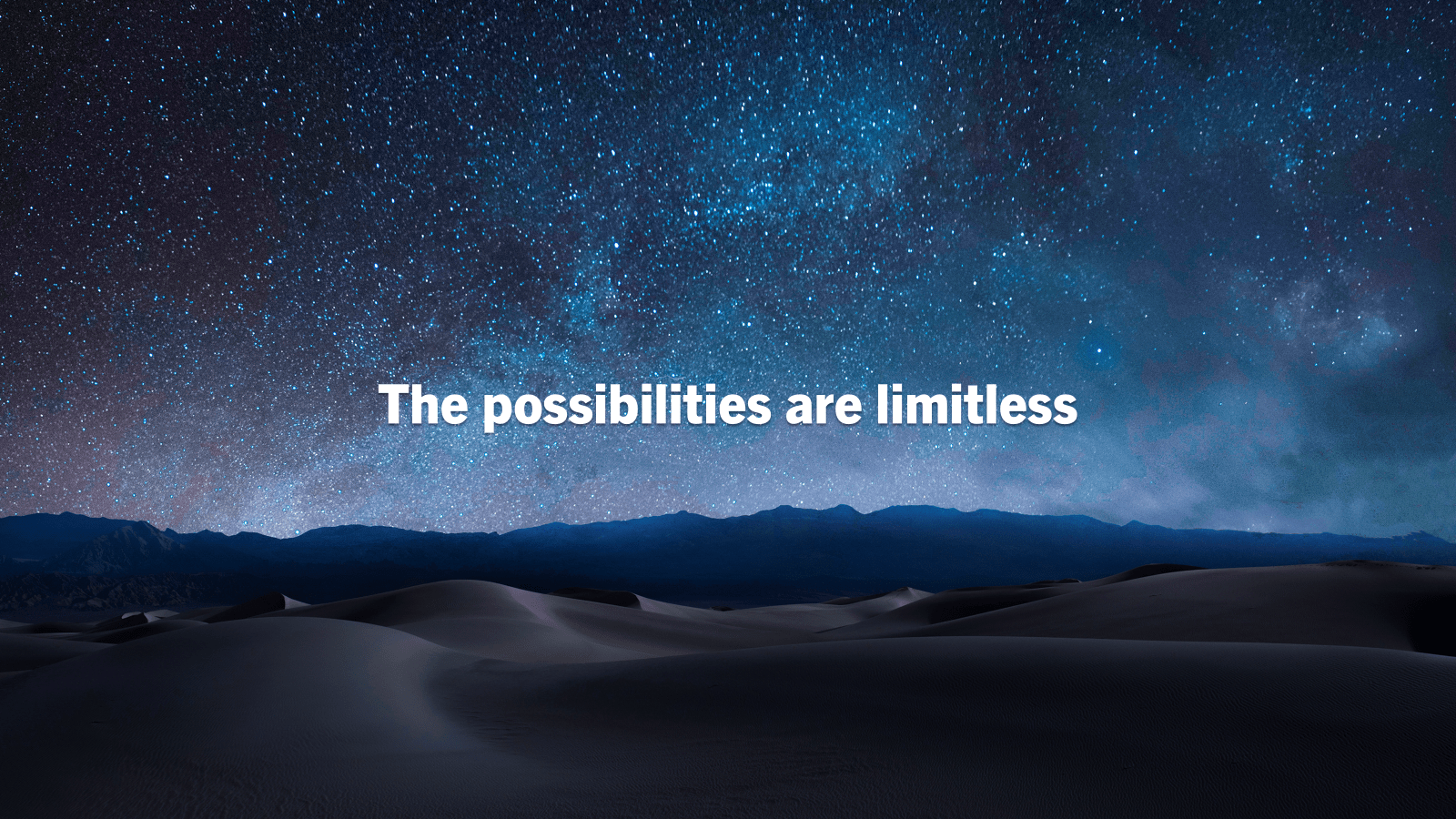 Dark mountains sit below a starry sky. White text reads 'The possibilities are limitless"